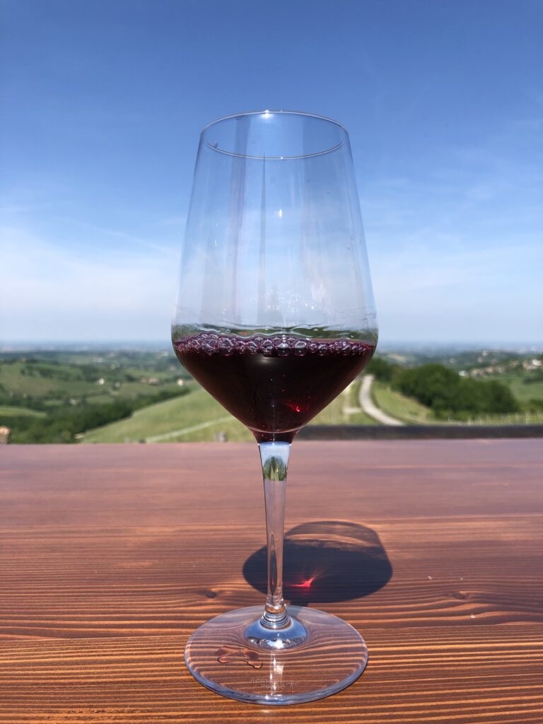 Glass of red sparkling wine by Cantina Il Poggio
